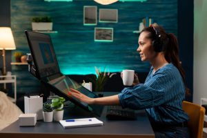 graphic-software-editor-with-headphones-working-e1696860851641.jpg