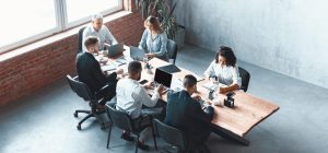 multiethnic-business-team-working-together-sitting-in-modern-office-panorama-e1696847130578.jpg