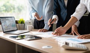 team-work-process-marketing-strategy-brainstorming-paperwork-and-digital-in-modern-office--e1696860779696.jpg