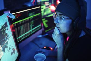 woman-computer-and-hacker-with-music-headphones-and-programming-for-cybersecurity-thinking-radio-e1696847117687.jpg